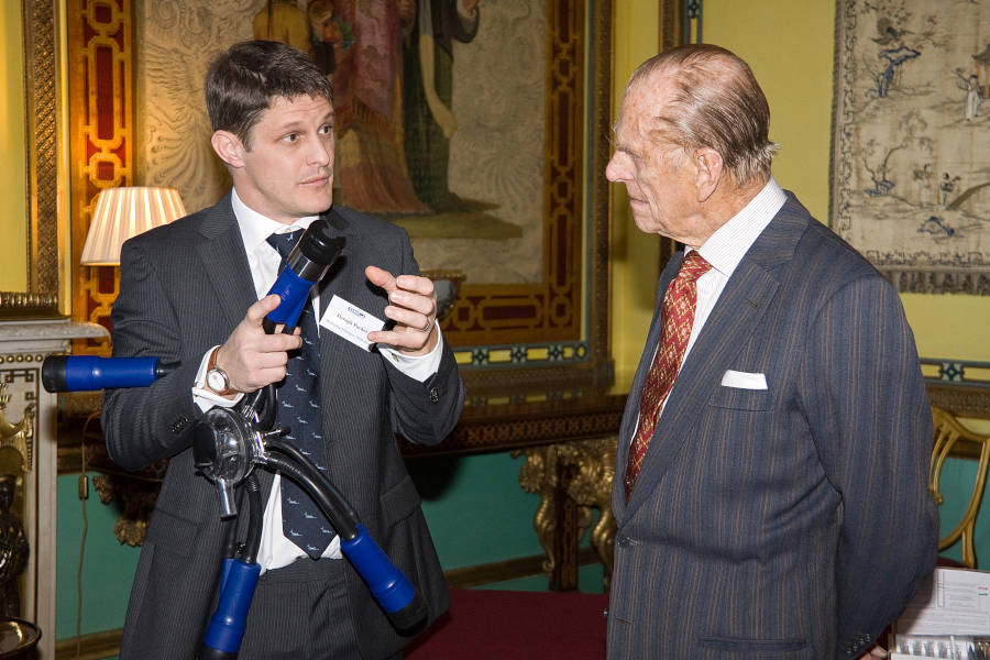 Daragh Parker, before starting PID, explaining an innovationaward winning new product to His Royal Highness Prince Philip at Buckingham Palace.